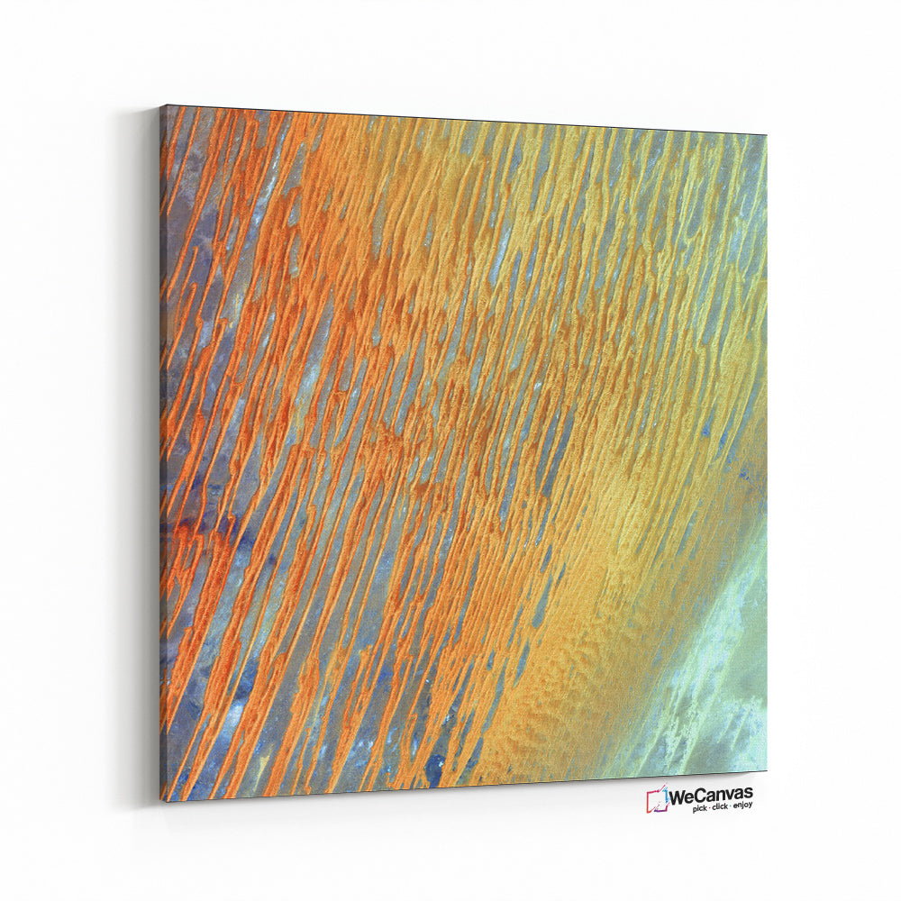 Ribbons of Saharan sand dunes seem to glow in sunset colors